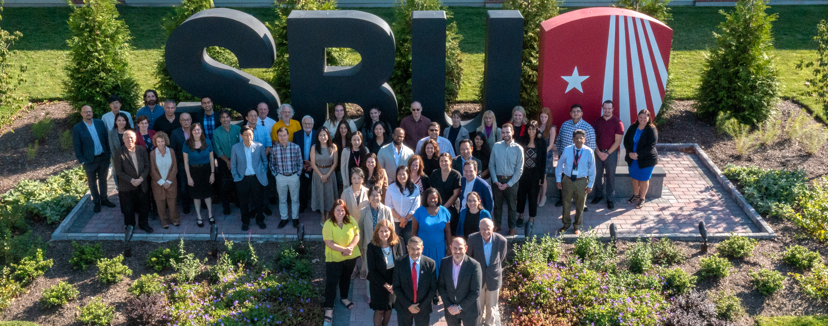 SUNY Stony Brook University College of Business Faculty and Staff Group Photo infront of the SBU Landmark Letters