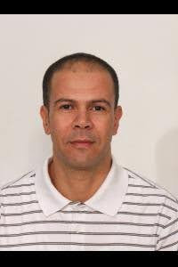 Nourredine Hamamouch Portrait of an individual wearing a striped shirt, set against a plain background.